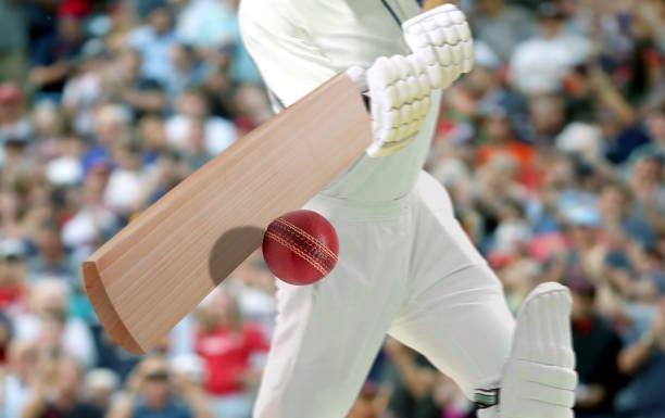 Cricket players batsman hitting ball in a stadium